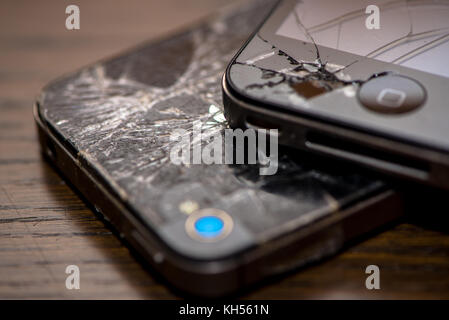 two smartphones, iphone, with broken glass Stock Photo