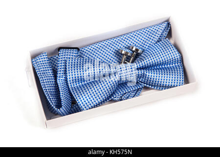 Close-up of cufflinks and bow tie fashion accessories in light box on white background Stock Photo