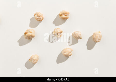 Cicer arietinum is scientific name of Chickpeas legume. Also known as Garbanzo bean, Chick Peas or Grao de Bico. Top view of scattered grains. Stock Photo