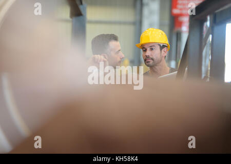 two engineers discussing a the factory Stock Photo