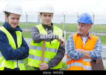 builders on building site with apprentices Stock Photo