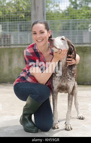 shelter keeper loves her residents Stock Photo