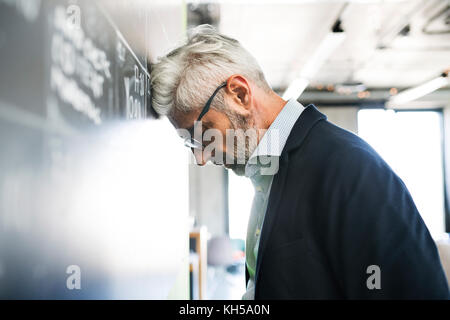 Worried mature businessman in the office. Stock Photo