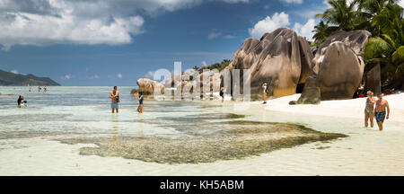 The Seychelles, La Digue, L’Union Estate, tourists on Anse Source d’Argent beach, panoramic Stock Photo
