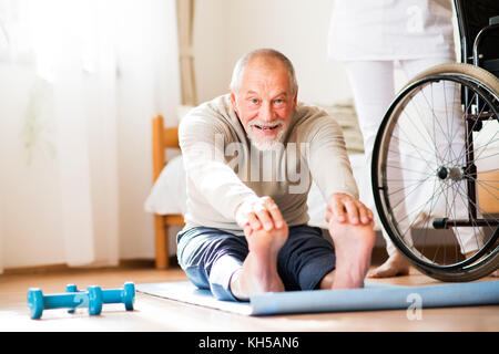 Health visitor and senior man during home visit. Stock Photo