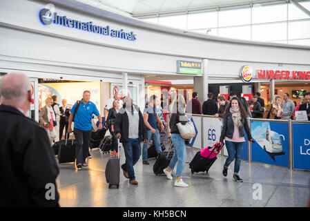 People arriving into UK via International Arrivals at Stansted Airport, UK Stock Photo
