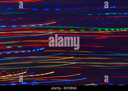 Abstract background. Bright glowing multicolored horizontal solid and dashed lines. Stock Photo