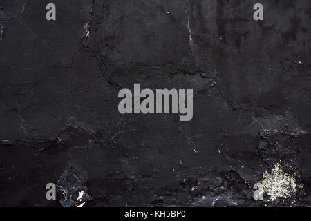 black concrete wall with stains of paint Stock Photo