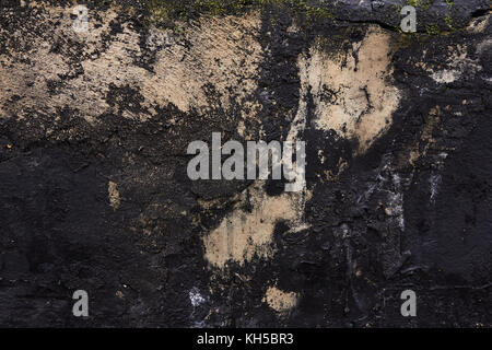 black concrete wall with stains of paint Stock Photo