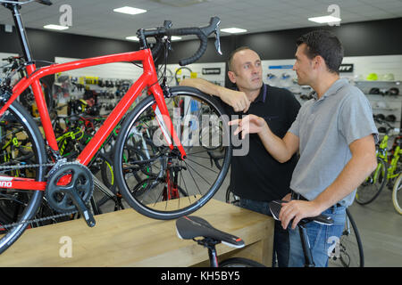 man looking for bicycle in bike shop Stock Photo