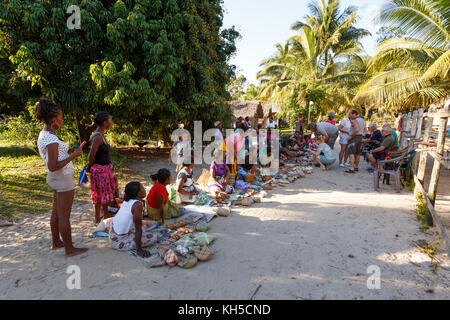 MAROANTSETRA, MADAGASCAR OCTOBER 23.2016 Malagasy woman from village selling traditional souvenir village street. Madagascar countryside scene. Maroan Stock Photo