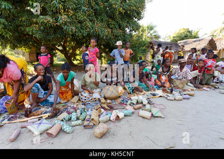 MAROANTSETRA, MADAGASCAR OCTOBER 23.2016 Malagasy woman from village selling traditional souvenir village street. Madagascar countryside scene. Maroan Stock Photo