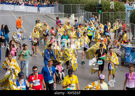 Athens, Greece - November 12, 2017: Marathon runners resting after finishing the 35th Athens Authentic Marathon race Stock Photo