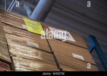 Pallets of USDA Emergency Food Assistance Program (TEFAP) commodities are shelved to the ceiling, on the Houston Food Bank commodity warehouse shelves, awaiting movement to packing lines or delivery to food pantries; pallets in the aisles are loaded with disaster assistance packages (those with orange wrapping have USDA Foods in them), and are ready for delivery or distribution to those in need, in Houston, TX, on September 22, 2017. Houston Food Bank Operations Associate Director Marly Maskill provided the following information; in general, the food bank usually receives approximately 10 truc Stock Photo