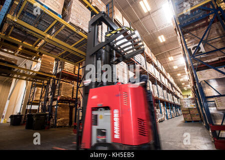 Pallets of USDA Emergency Food Assistance Program (TEFAP) commodities wait on the Houston Food Bank commodity warehouse shelves for movement to packing lines or delivery to food pantries; pallets in the aisles are loaded with disaster assistance packages (those with orange wrapping have USDA Foods in them), and are ready for delivery or distribution to those in need, in Houston, TX, on September 22, 2017. Houston Food Bank Operations Associate Director Marly Maskill provided the following information; in general, the food bank usually receives approximately 10 trucks per day and distributes ap Stock Photo