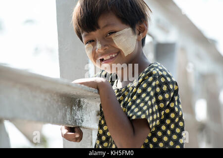 Smiling Birmese girl with traditional Tanaka face paint. February 22, 2014 - Yangon, Myanmar Stock Photo