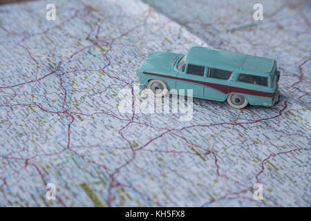 A vintage toy car on a old map Stock Photo