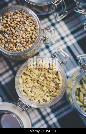Whisky and Gin Ingredients: in glass jar on blue and white tartan Stock Photo
