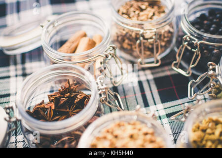 Whisky and Gin Ingredients in glass jar on blue and white tartan Stock Photo