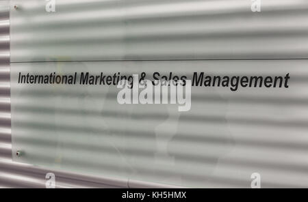 Textual commercial message printed on white glass. Stock Photo