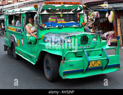 Jeepneys, the Philippine version of a taxi and minibus, are roaming the streets of Manila, Philippines Stock Photo