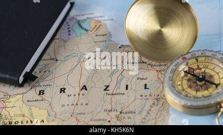 Compass on a close up map pointing at Brazil and planning a travel destination. Stock Photo