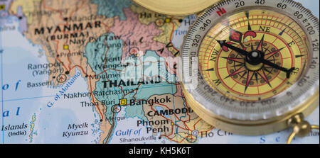 Compass on a close up map pointing at Thailand and planning a travel destination. Stock Photo