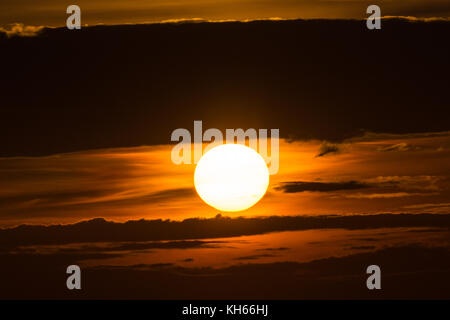 The bright sun between clouds during a nice sunset Stock Photo