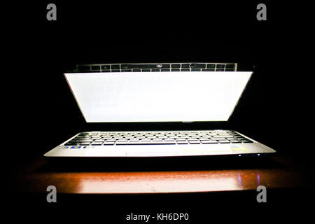 Laptop in a Dark Room, Screen Illuminated Stock Photo