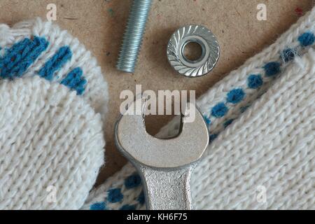 Workplace mechanic wrench gloves bolt and nut macro shot Stock Photo