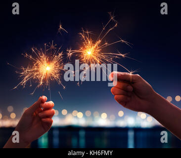 Couple holding a burning sparklers Stock Photo