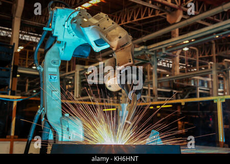 Team robots are welding automotive part. Stock Photo
