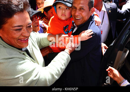 A boy says goodbye to president Ollanta Humala (centre) as he tries to leave the Virgen de la Candelaria festival, Puno, Peru Stock Photo