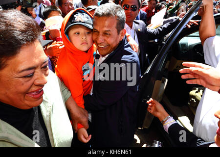 A boy says goodbye to president Ollanta Humala (centre) as he tries to leave the Virgen de la Candelaria festival, Puno, Peru Stock Photo