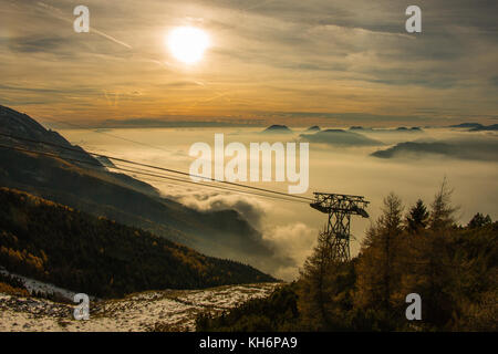 The sunset over a sea of clouds above Malcesine Lake Garda of Italy Stock Photo