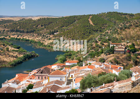 View of Guadiana river bend and residential houses of Mertola city on the riverside as seen from the Castle hill. Mertola. Baixo Alentejo. Portugal Stock Photo