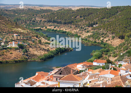 View of Guadiana river bend and residential houses of Mertola city on the riverside as seen from the Castle hill. Mertola. Baixo Alentejo. Portugal Stock Photo