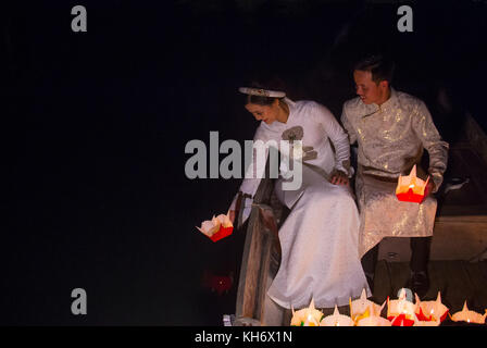 Vietnamese couple holding lanterns before droping them into the river in Hoi An Stock Photo