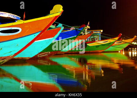 colorful fishing boats in Hoi an Vietnam night time long exposure Stock Photo