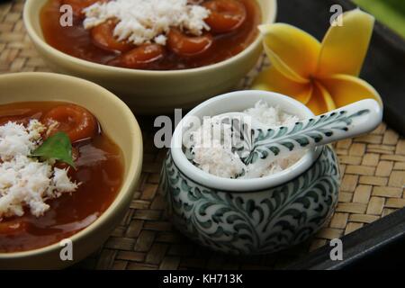 Grated Coconut in Fancy Ceramic Bowl, Topping for Balinese Jaja Batun Bedil Stock Photo