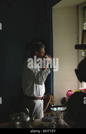 Thoughtful senior man having coffee in kitchen at home Stock Photo