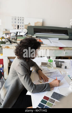 Beautiful female architect working in the office Stock Photo