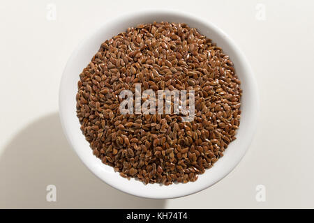 Linum usitatissimum is scientific name of Brown Flax seed. Also known as Linseed, Flaxseed and Common Flax. Pile of grains, isolated white background. Stock Photo