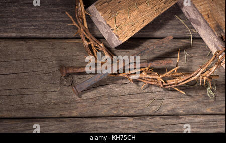 Crown of thorns and nails on a wood surface Stock Photo