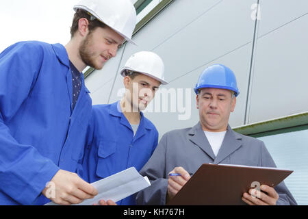 students engineers examining construction site outdoors Stock Photo