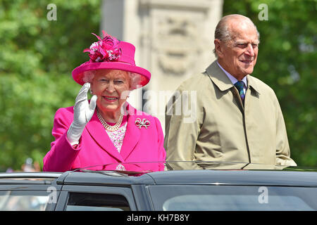 12/06/2016. Queen Elizabeth II and the Duke of Edinburgh make their way down The Mall in an open-topped Range Rover, during the Patron's Lunch in central London in honour of the Queen's 90th birthday. The Royal couple will celebrate their platinum wedding anniversary on November 20.