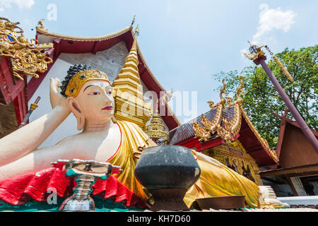 Myanmar style reclining Buddha Image in Thailand Buddhist temple. Stock Photo