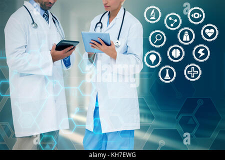 Doctors discussing something on clipboard against curved white room Stock Photo