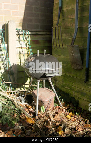 black kettle barbeque stood in a garden in autumn Stock Photo