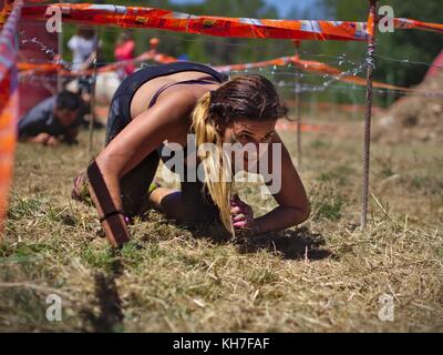 Photos taken in the race Eternal Running 2017 in Pallaresos, Tarragona, Spain.Young athletes females in passing one of the hundreds of obstacles. Stock Photo